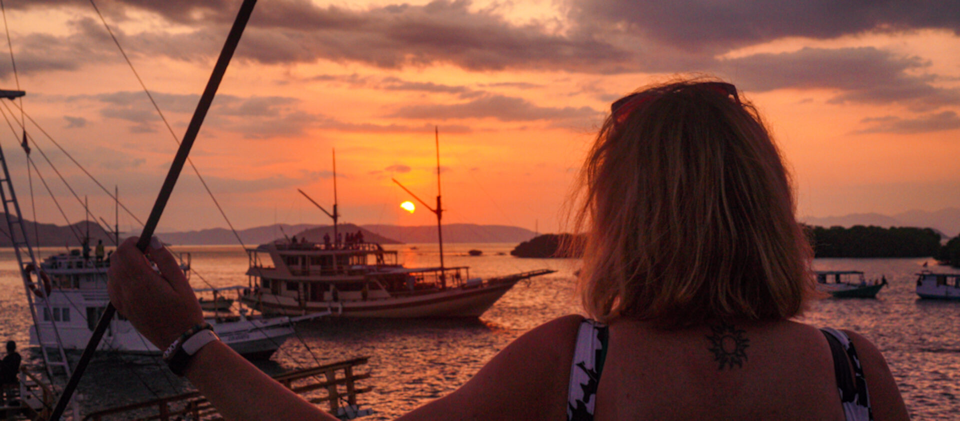 Em on a boat at sunset