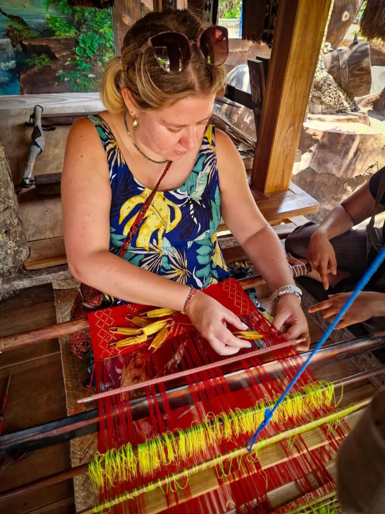 Em using a weaving loom