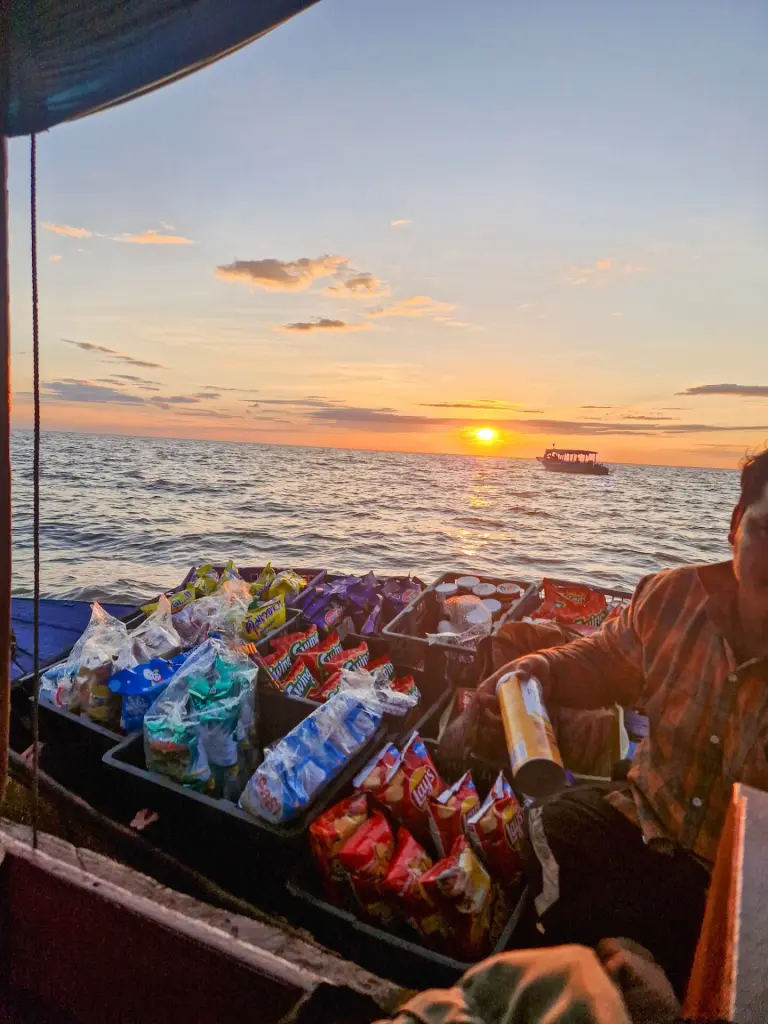 A boat at sunset with a drinks and snacks