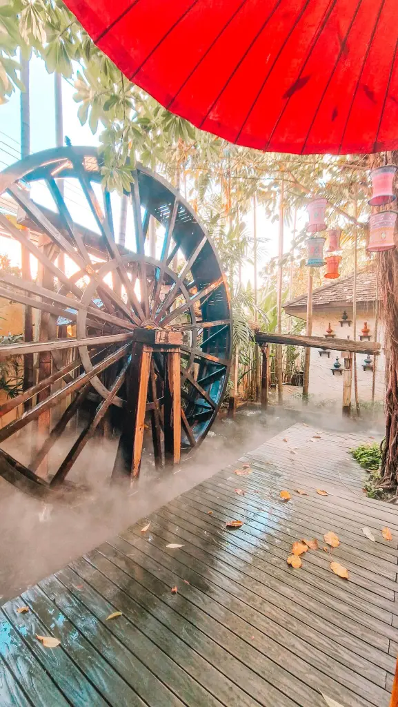 Inside Fahtara Cafe Chiang Mai, with a waterwheel feature