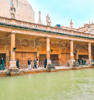 Green water in front of a colonaded walkway