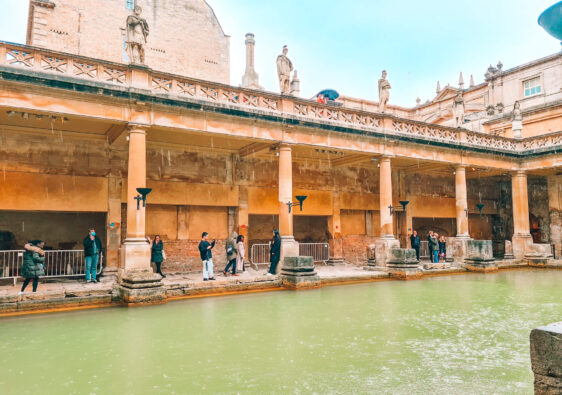 Green water in front of a colonaded walkway