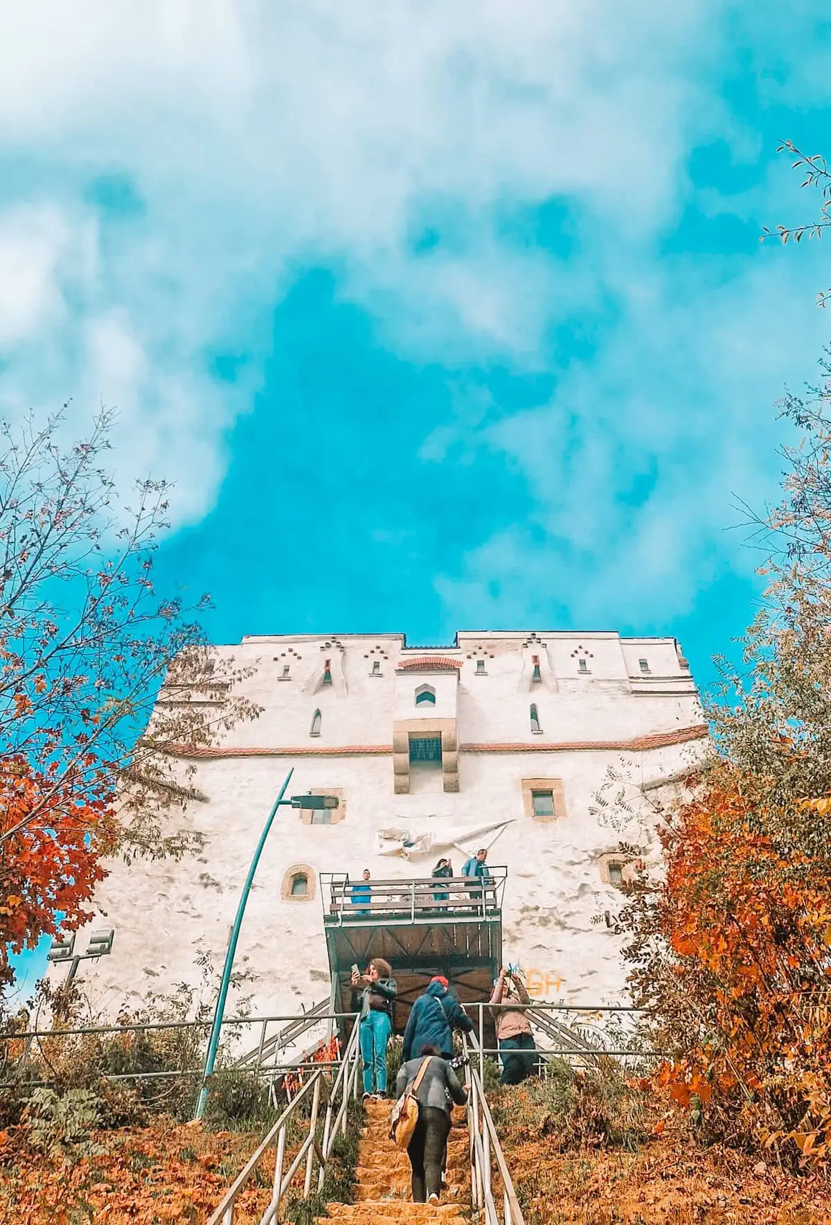 A steep climb to a white medieval tower
