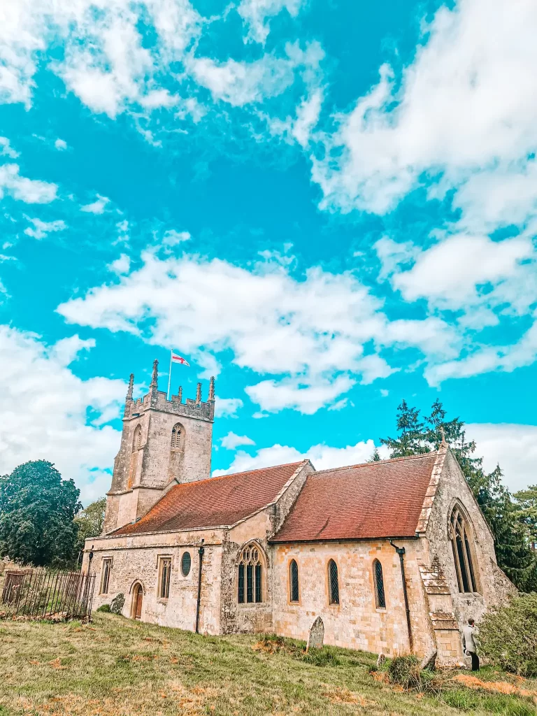 small medieval church wtih tower in field