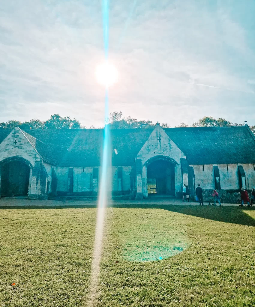 Large barn structure with sun behind 