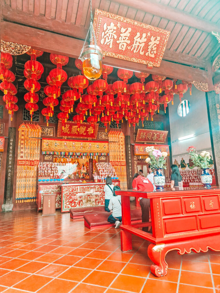 temple interior with red laterns and shrine