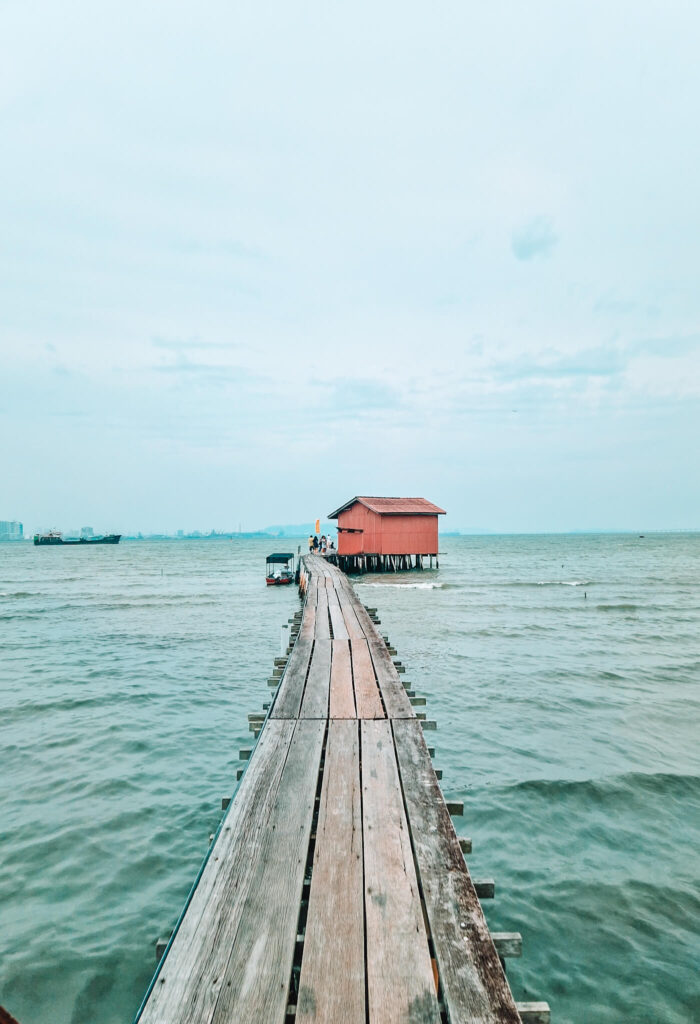 narrow wooden walkway over water