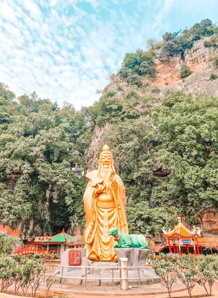 Golden Buddha surrounded by greenery