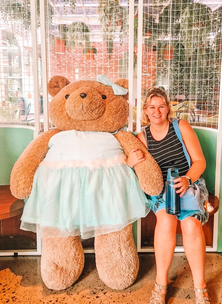 Em with a bear in a dress that is bigger than Em