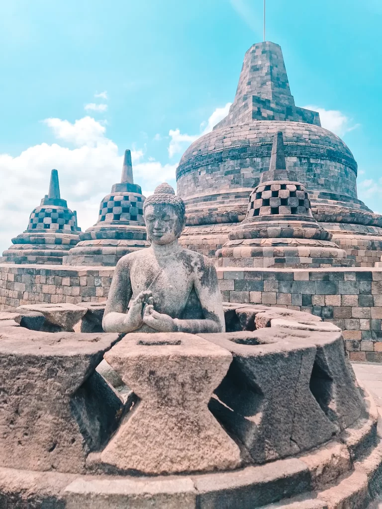 Statue in front of stupas at Borobudur temple