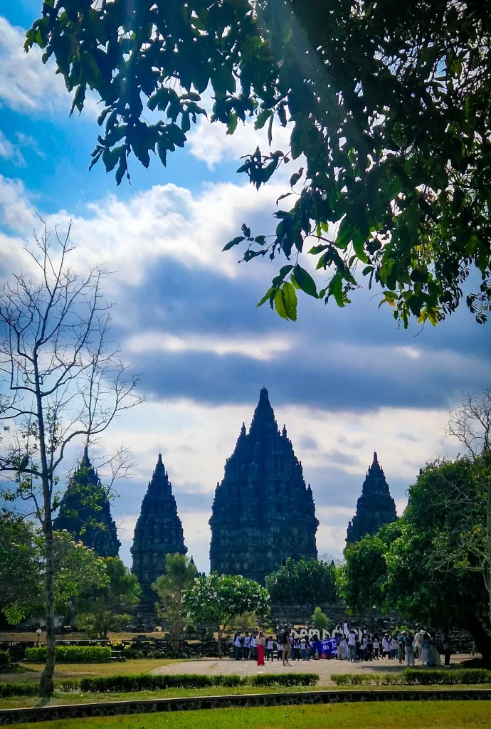 Four large temple turrets seen in the distance with trees in front