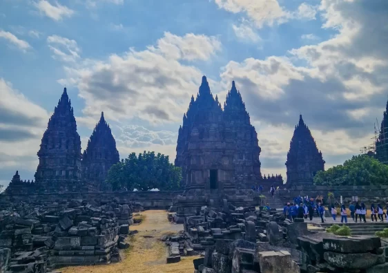 Restored temples at Prambanan, with piles of rubble in front where other temples have yet to be restored