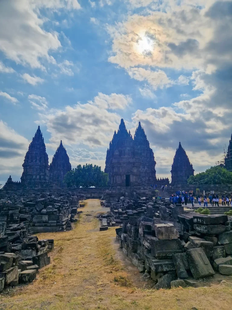 Restored temples at Prambanan, with piles of rubble in front where other temples have yet to be restored