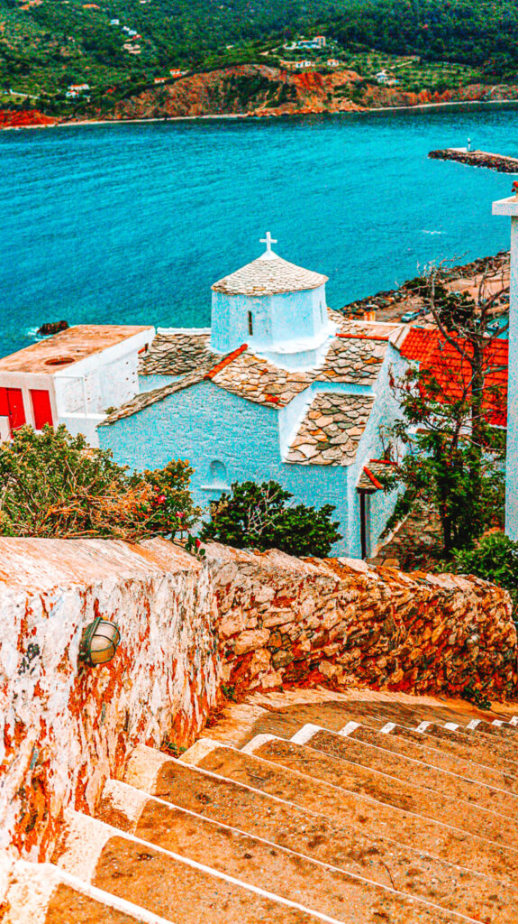 Steps leading down to a white building, above the sea