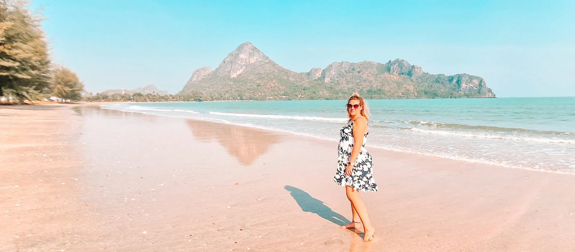 Em, a solo female traveller, on a beach