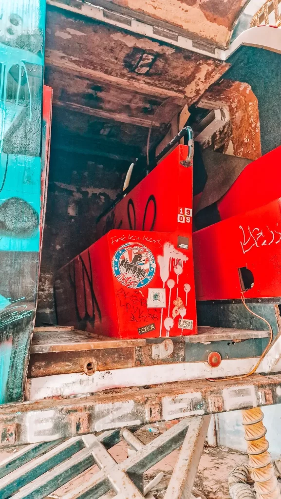 Close-up of a rusty, graffiti-covered simulator at the abandoned water park, showing off the gritty urban exploration adventures possible during 2 days in Hue.