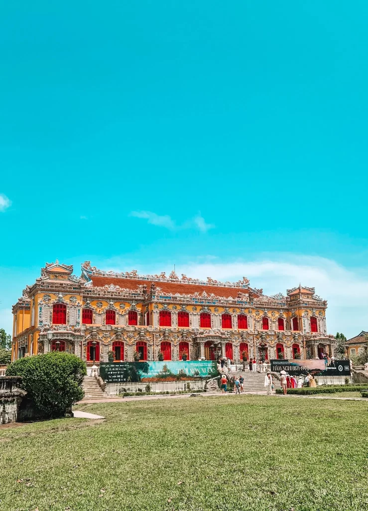 The beautifully restored facade of the Royal Palace in the Imperial City, adorned with red shutters and intricate carvings—an essential stop during 2 days in Hue.