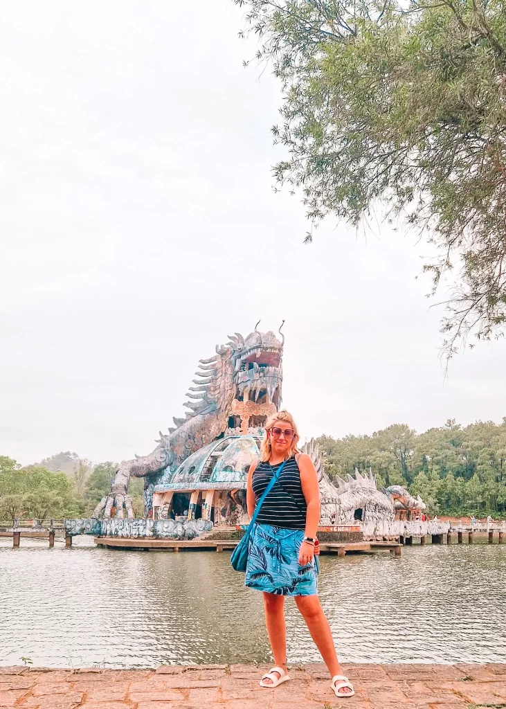 A woman posing in front of the giant dragon structure at the abandoned Hồ Thủy Tiên water park, one of Hue’s most unique attractions to explore in 2 days in Hue.