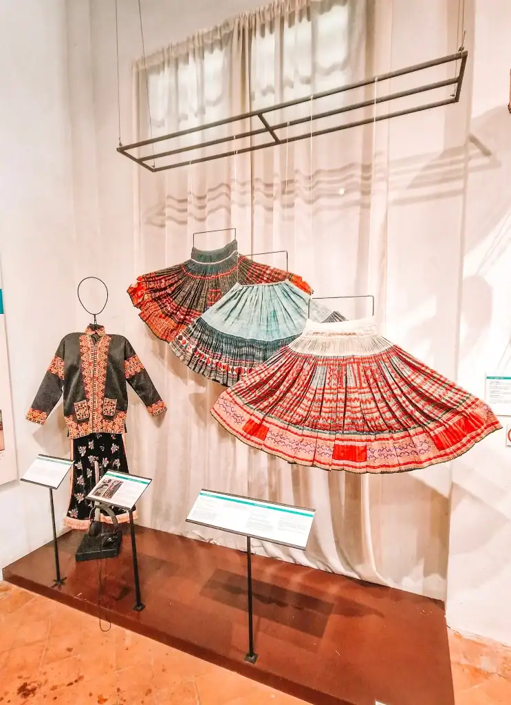 Colorful traditional skirts and embroidered garments on display at the Traditional Arts and Ethnology Centre, showcasing local culture and ranking high among the best things to do in Luang Prabang.