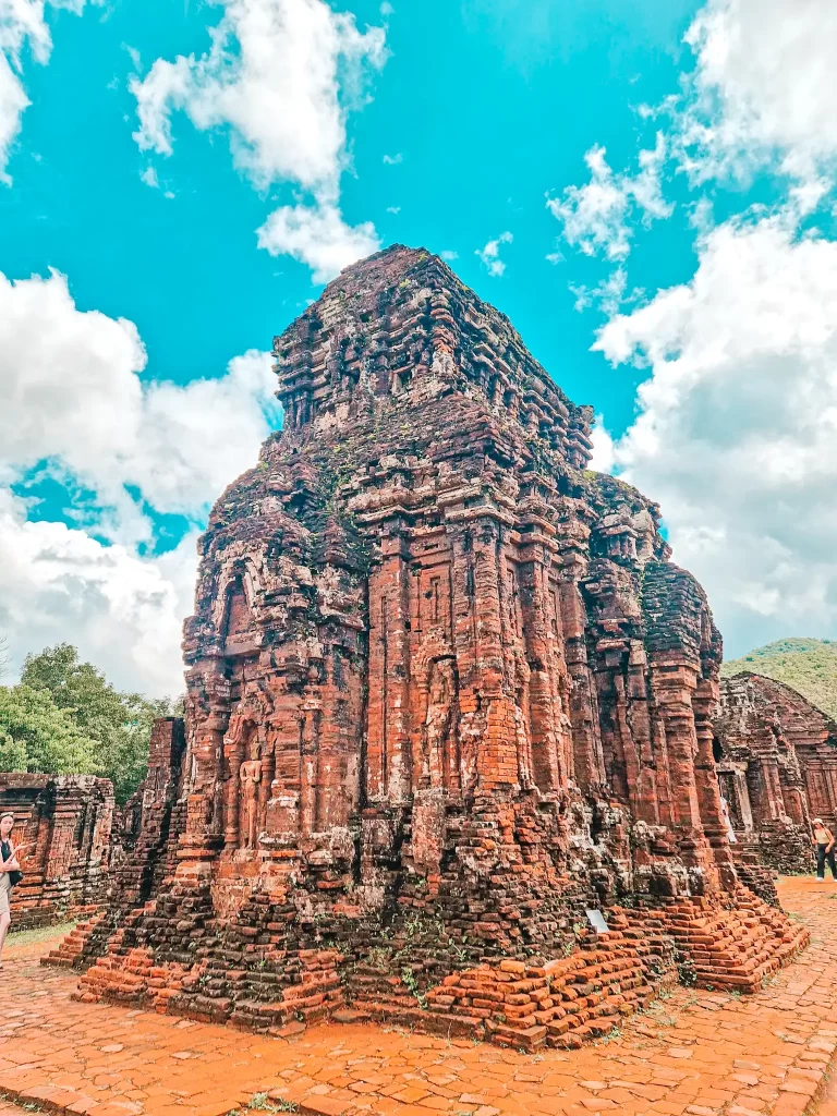 A towering, intricate Cham temple ruin made of red bricks, showcasing centuries-old architecture and carvings—perfect for history enthusiasts on day trips from Hoi An.
