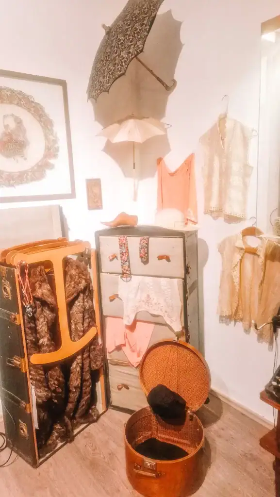 A charming exhibit featuring antique clothing, fur coats, parasols, and travel trunks from Albanian women’s past, inside the MiG Women’s Museum.