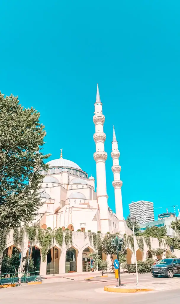 A striking view of the new Grand Mosque with its twin minarets and large central dome, standing tall under a bright blue sky—an architectural highlight in 48 hours in Tirana.