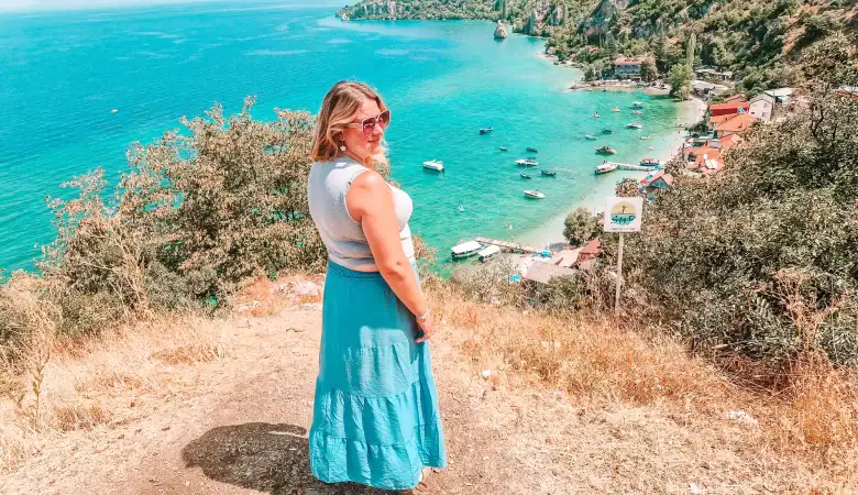 Em overlooking the turquoise waters of Lake Ohrid in North Macedonia, with boats docked along the coast, showing why it’s a must-visit for lakeside relaxation and scenic villages.