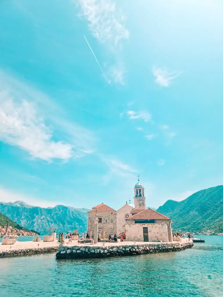 he small island of Our Lady of the Rocks off the coast of Perast in Montenegro features a picturesque stone church and mountain views, perfect for boat trips and cultural exploration.