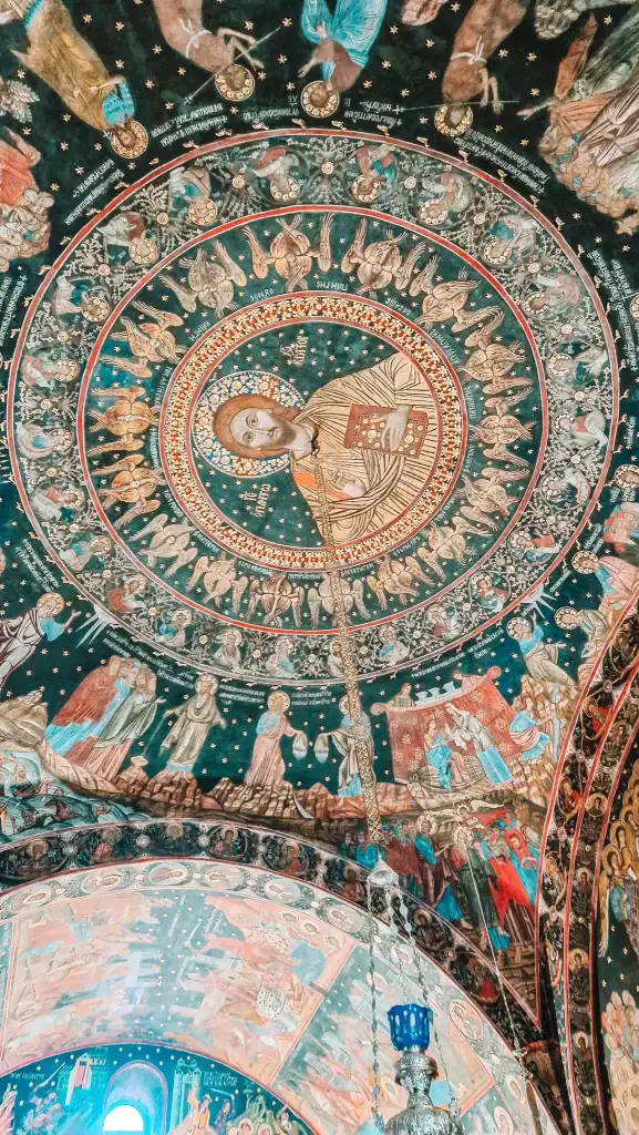 Detailed fresco of Christ Pantocrator surrounded by angels and saints on the domed ceiling of Bachkovo Monastery, a highlight of Plovdiv day trips.