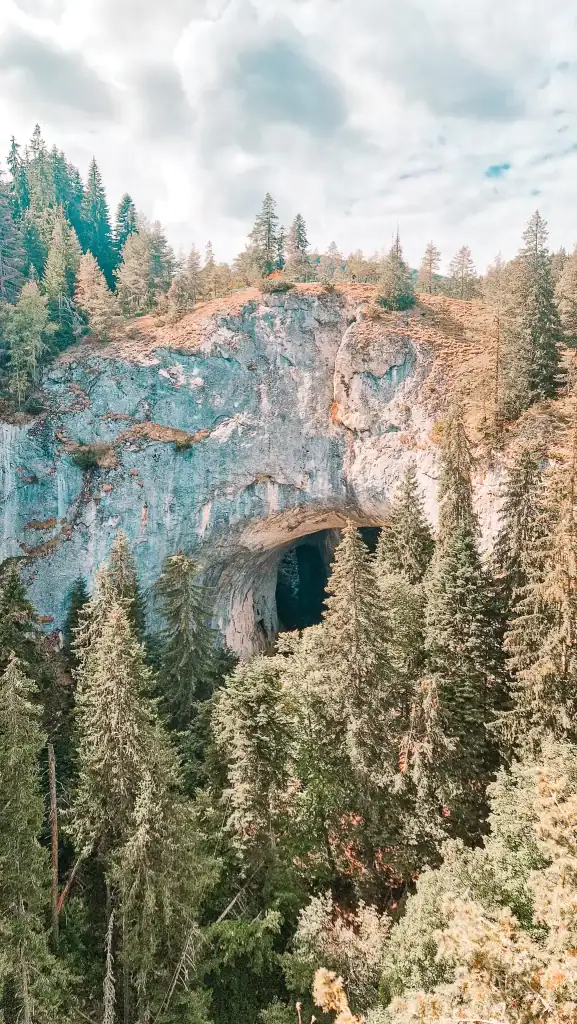 Vertical view of the towering stone arch of the Wonderful Bridges, a dramatic natural landmark in the Rhodope Mountains.