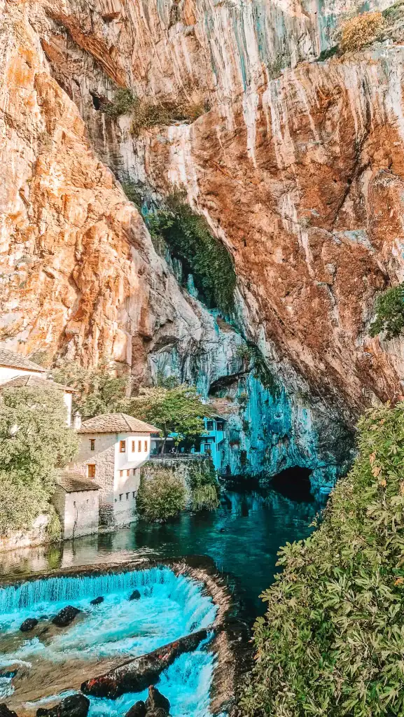Blagaj Tekke sits beneath towering cliffs, surrounded by cascading waterfalls and lush greenery, where a cave mouth opens to the Buna River. This spiritual and scenic site is a peaceful must-see just outside Mostar.